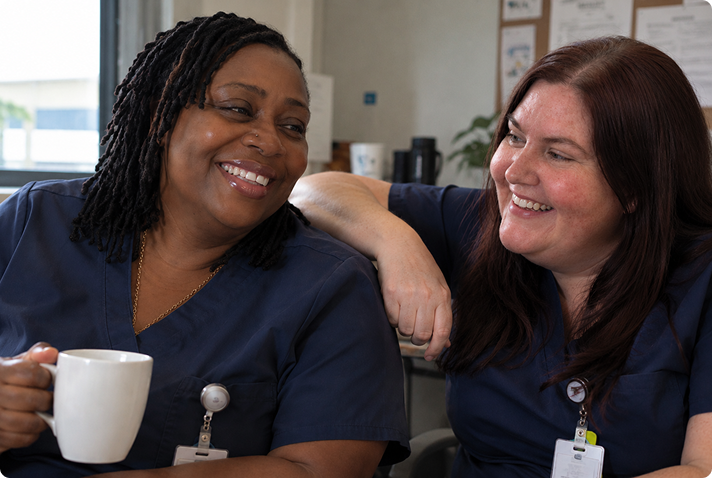 Two caregivers sharing a smile